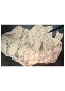 Graphite drawing of wadded sheet music, art by Meelena Spikes.